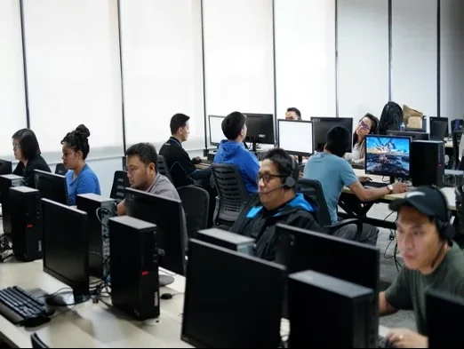 OutForce team members working at their desks in the Ortigas office